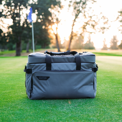 Clutch golf cart cooler in Navy/Grey on a golf course at sunset
